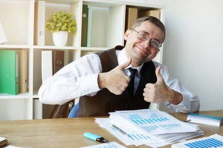 Happy accountant with annual report and business papers.